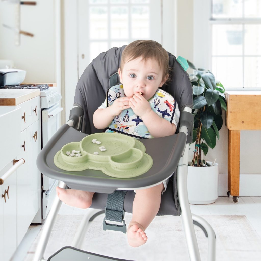 baby on high chair with emerald silicone plate