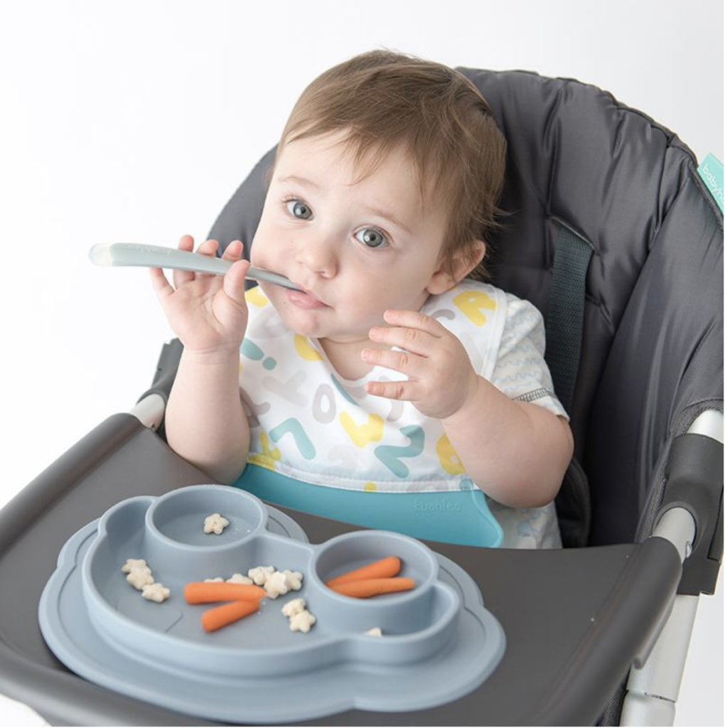 baby eating on high chair